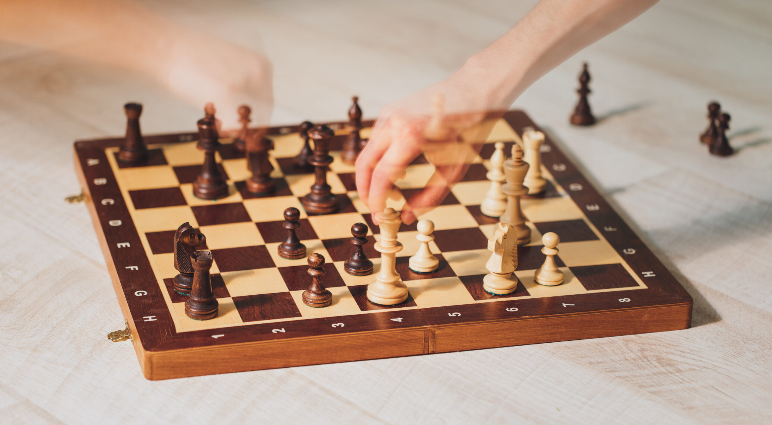 hands playing chess with motion ghost effect